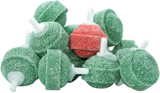 Amid a sea of green round air stones used for fish tank cleaning services, one striking red candy stands out at the center. It's as if an aquarium maintenance team carefully curated this sweet display with precision and style.